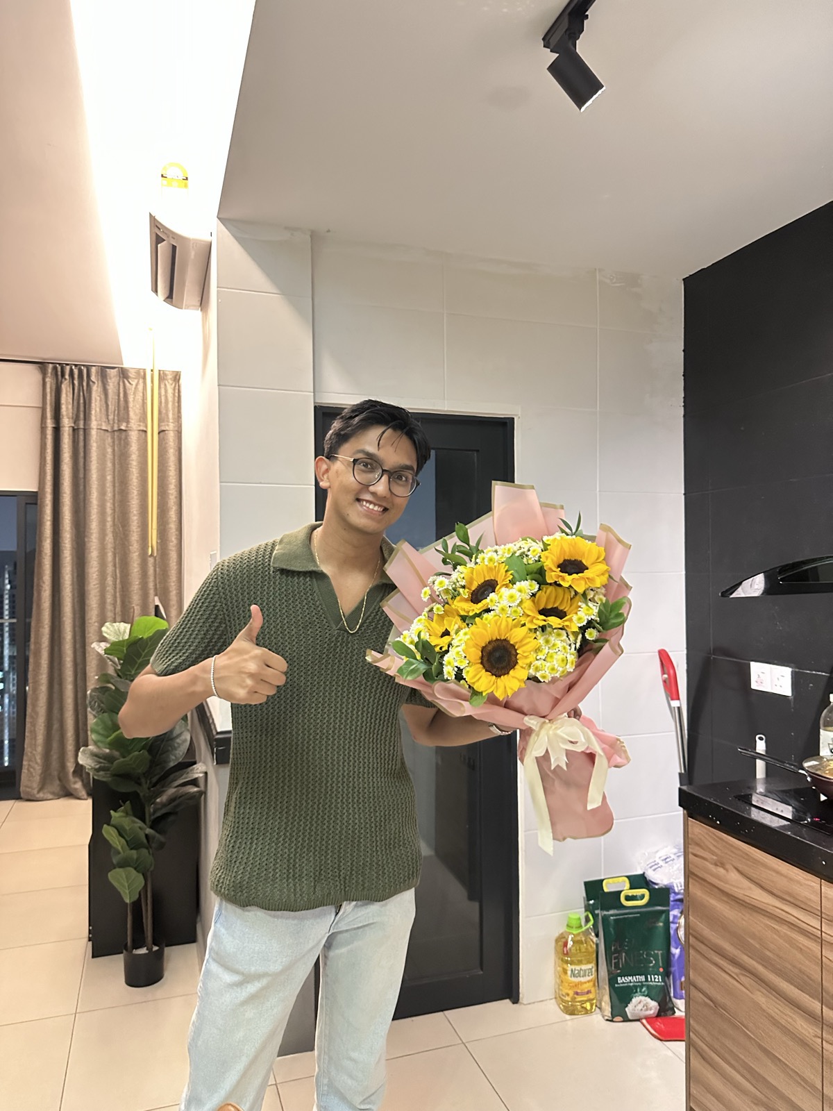 Devam holding a sunflower bouquet